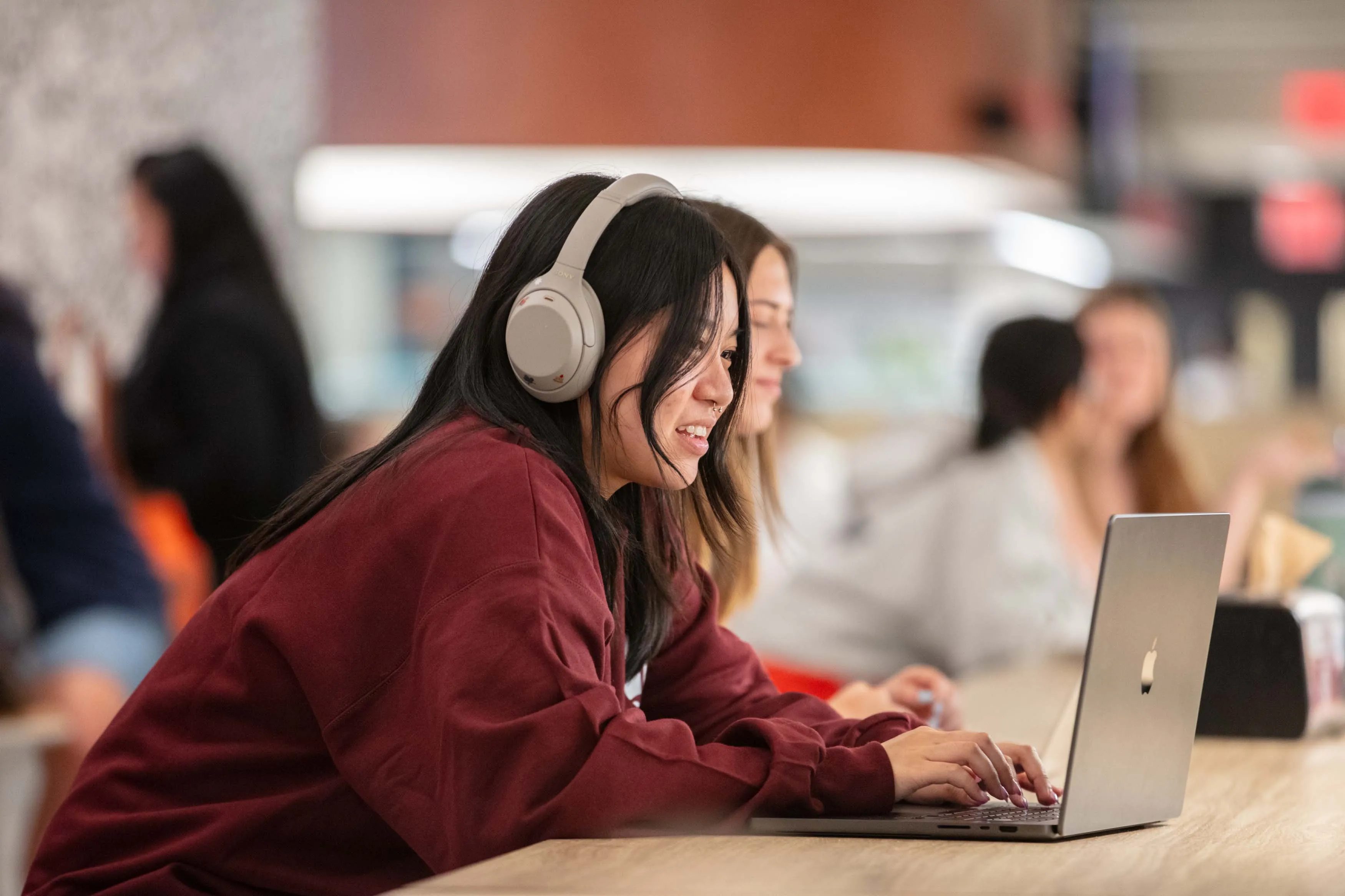 student with headphones and laptop