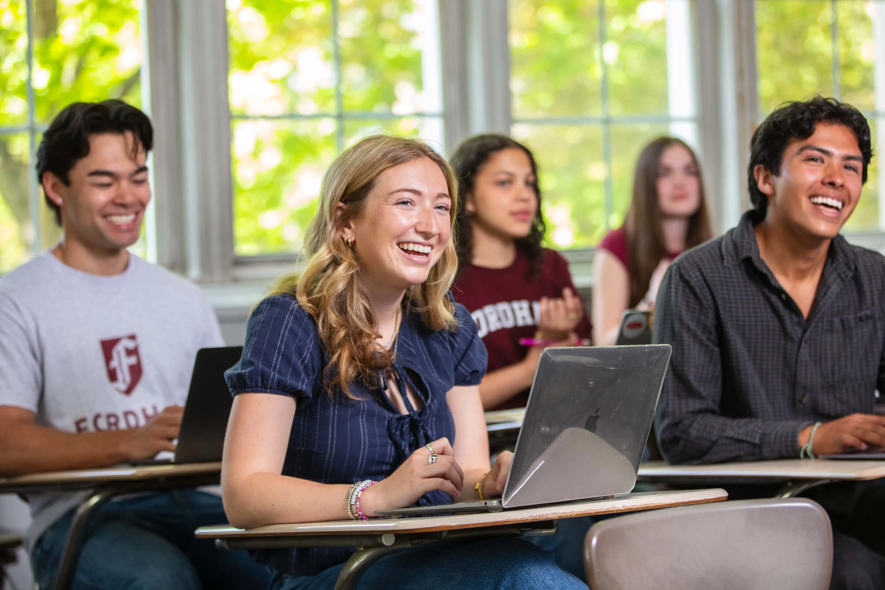 students sitting in classroom at desk smiling