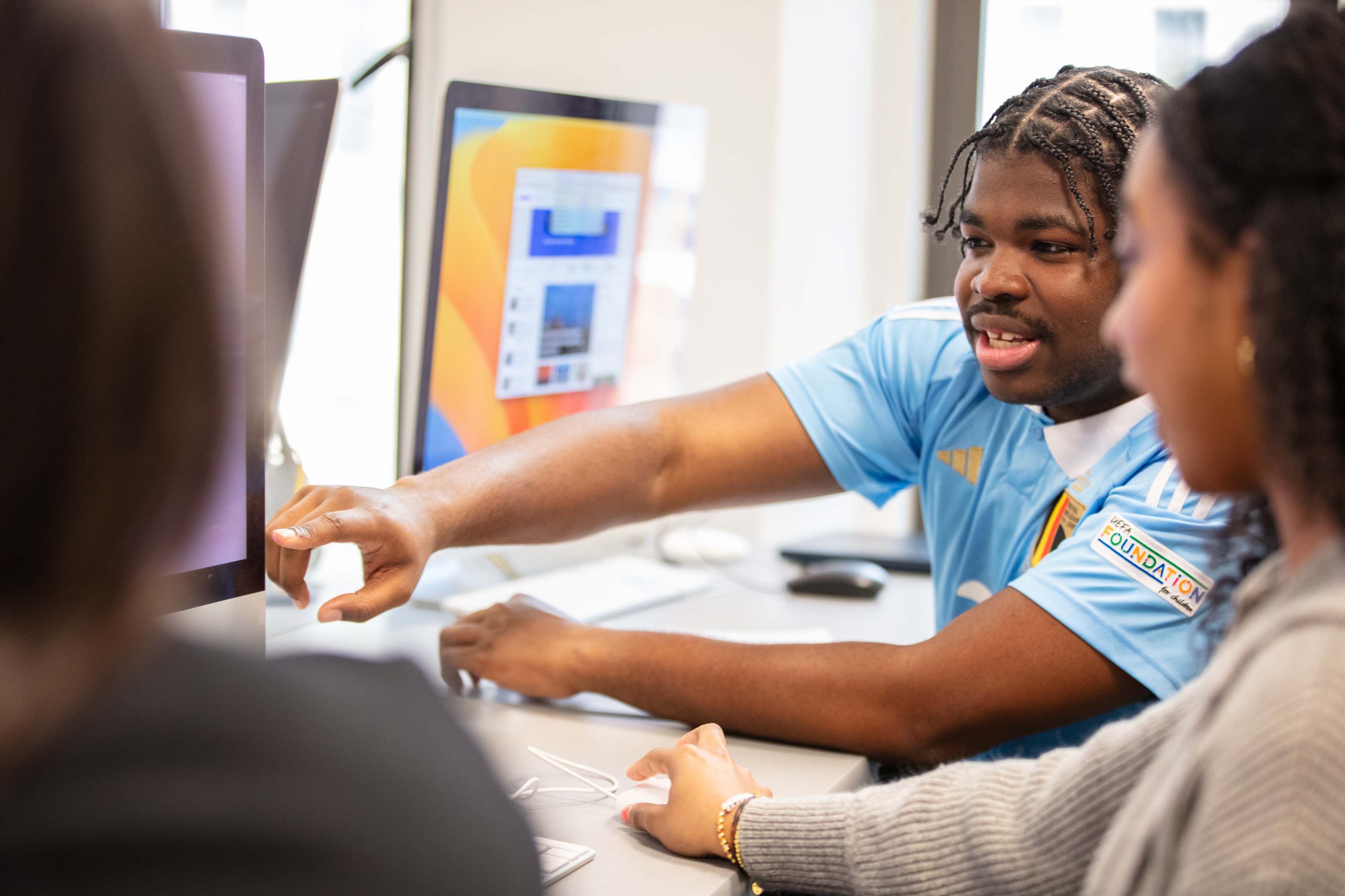 three students looking at computer screen