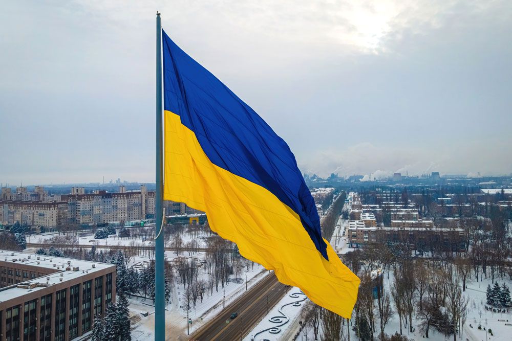 An arial shot of the Ukraine flag flying above a Ukrainian city