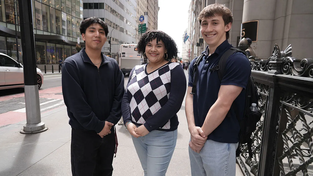 Cristian Bravo, Isabella Luquez, and Alex Grzebielucha stand on a street in NYC