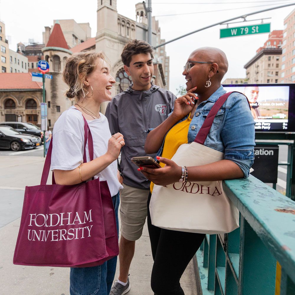 Three students talk near the subway at 79th street