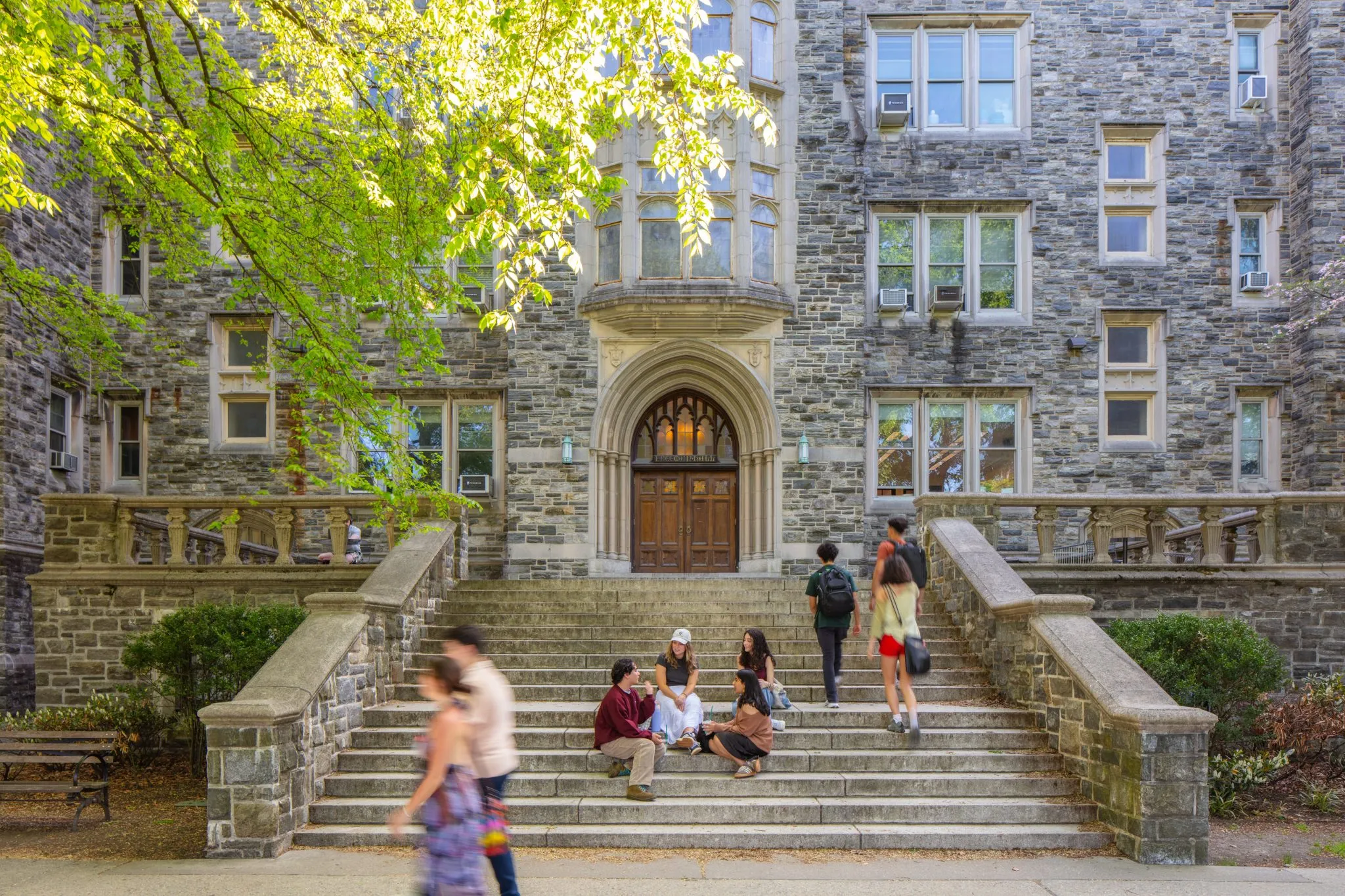 Students walking in front of Freeman Hall on the Rose Hill Campus