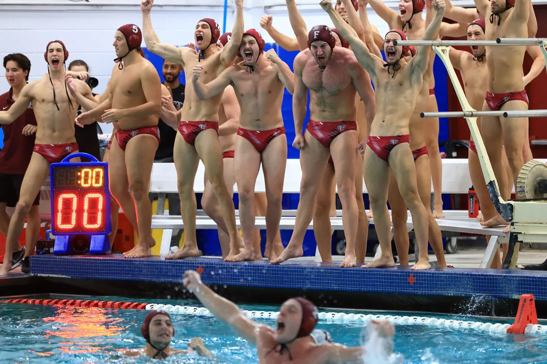 The water polo team celebrating a win in the pool
