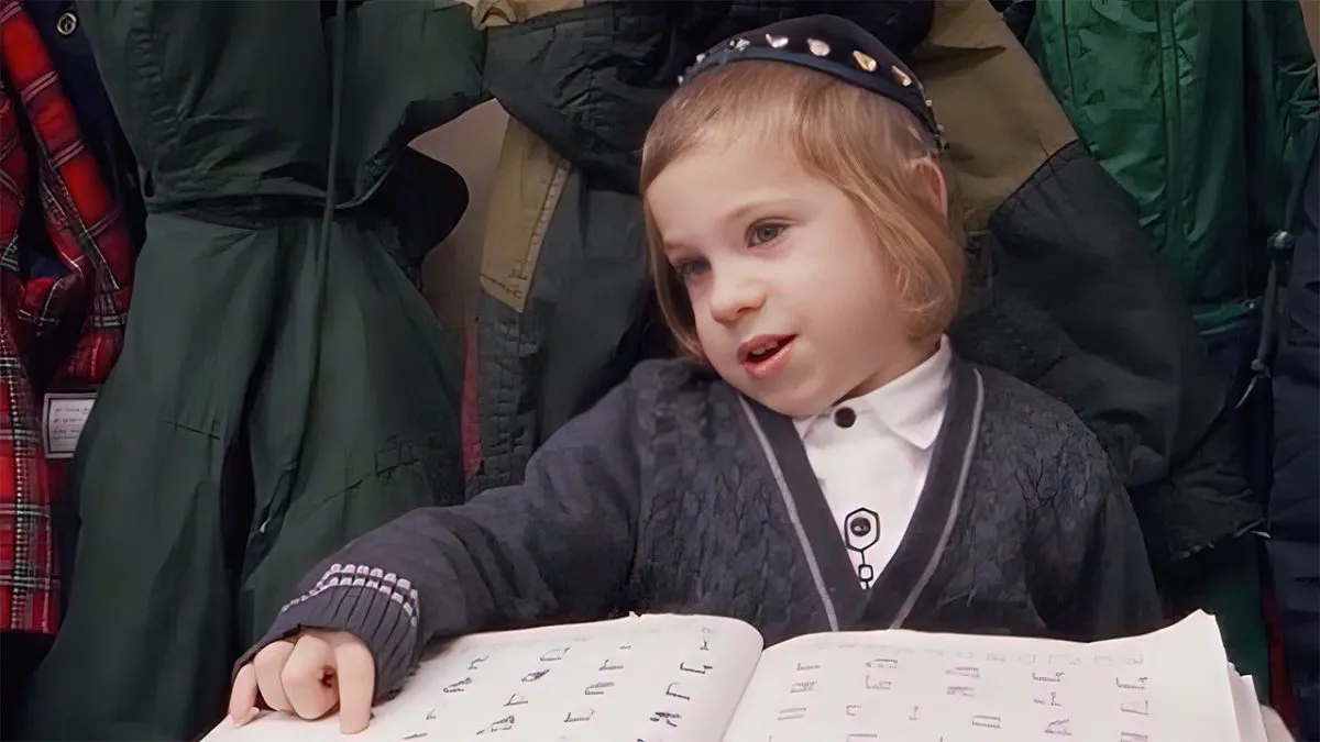A movie still from Menachem Daum's film, A Life Apart, showing a young Hasidic boy