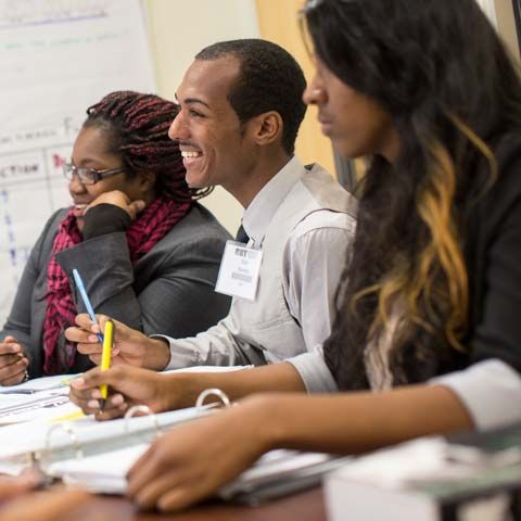 Graduate Students Smiling in Classroom