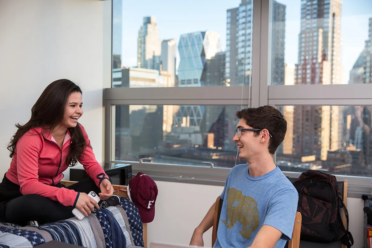 Two students having a conversation in a dorm room in McKeon Hall