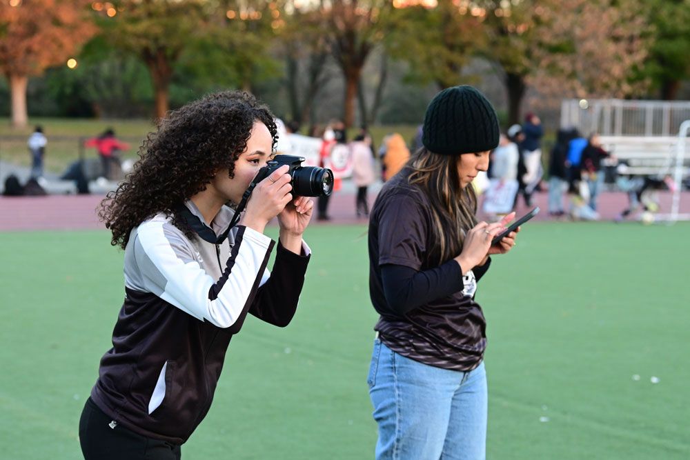 Student interns take pictures and video for social media