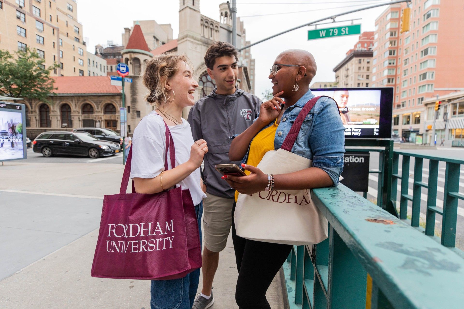 Group of students talking in front of subway station