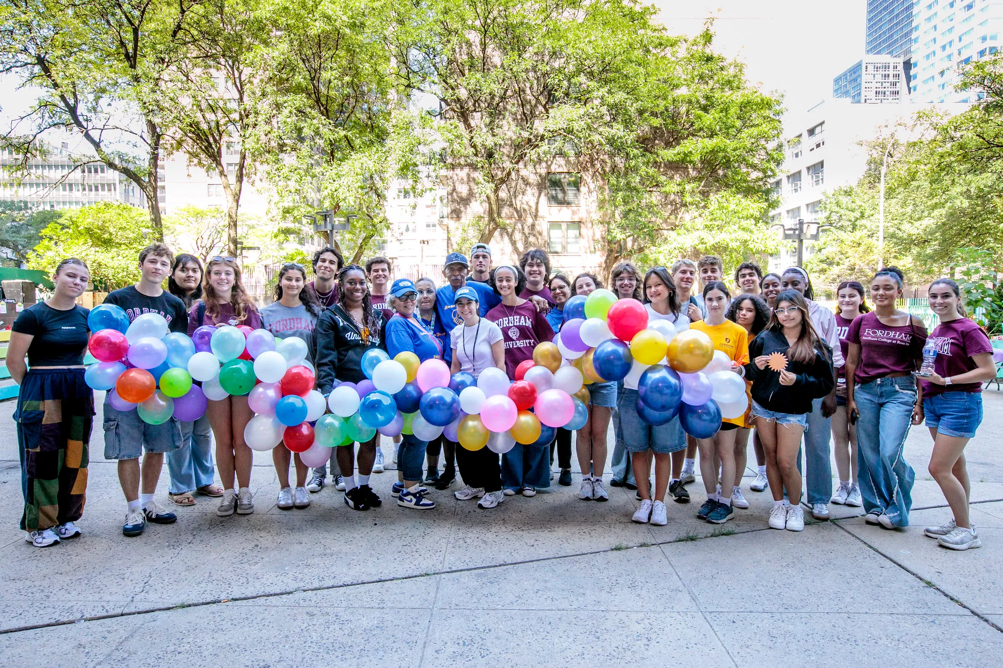 Fordham Urban Plunge student Volunteers/ bright balloons / with Ten Assn members at Harborview Houses 2025