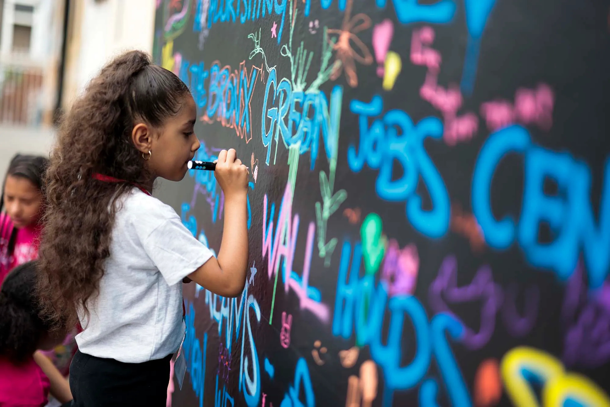 Kids painting a mural