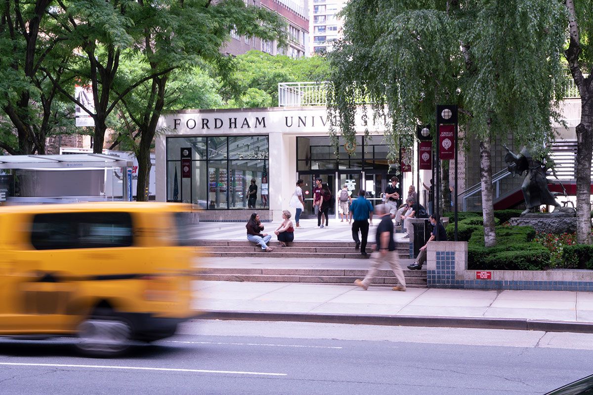 Fordham College Lincoln Center main entrance with taxi passing by