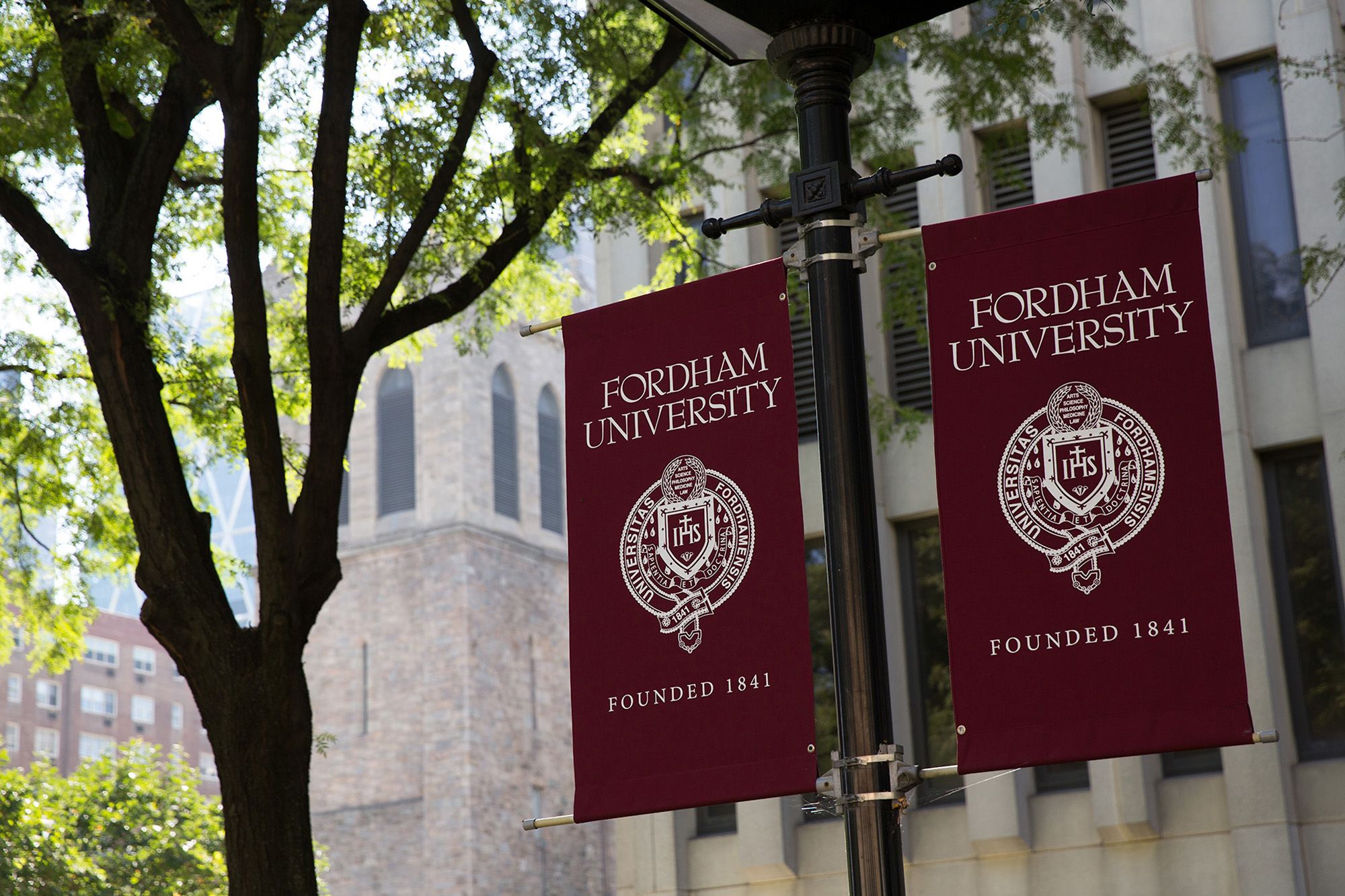 Image of Fordham flags with logo and Seal