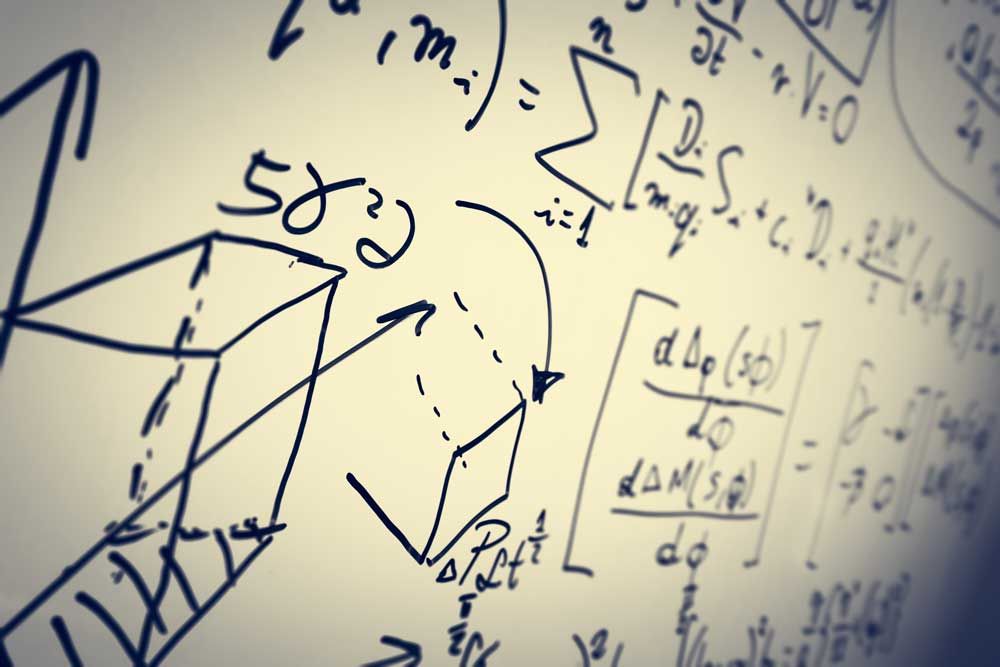 Mathematical formulas displayed on a white board