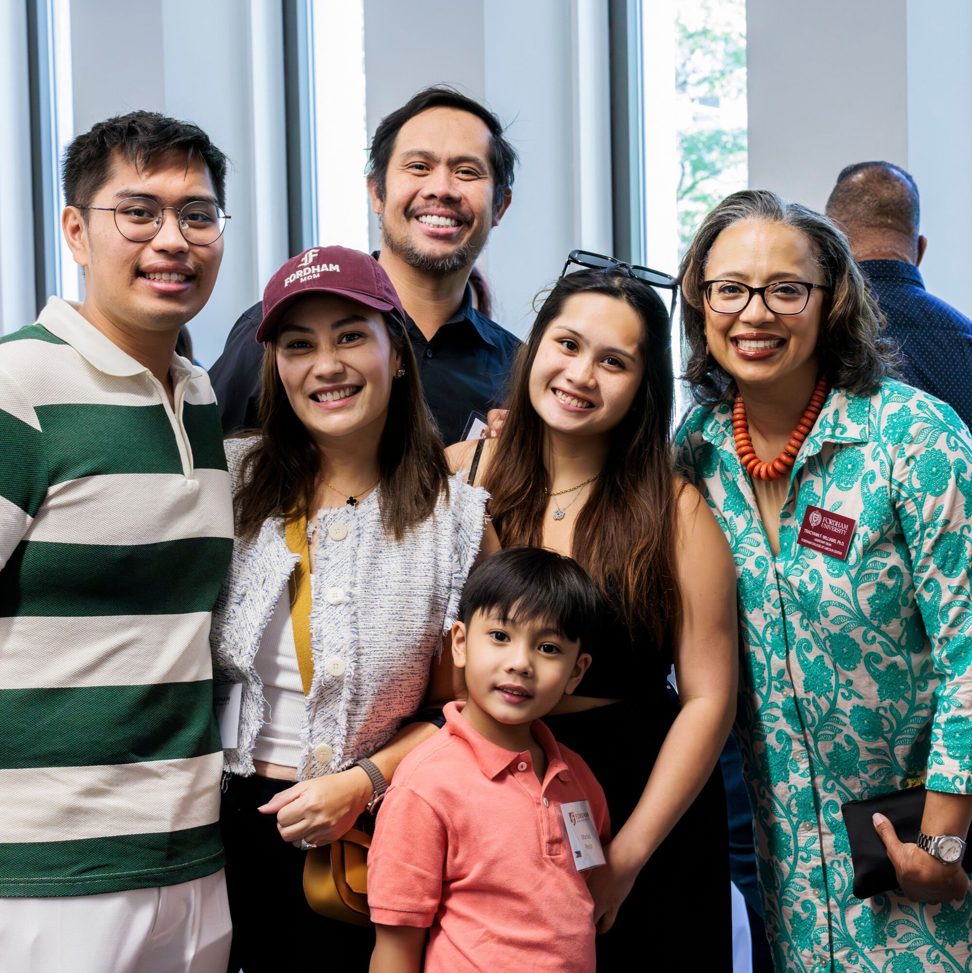 Family posing with Dean at welcome reception inside of Lowenstein Center