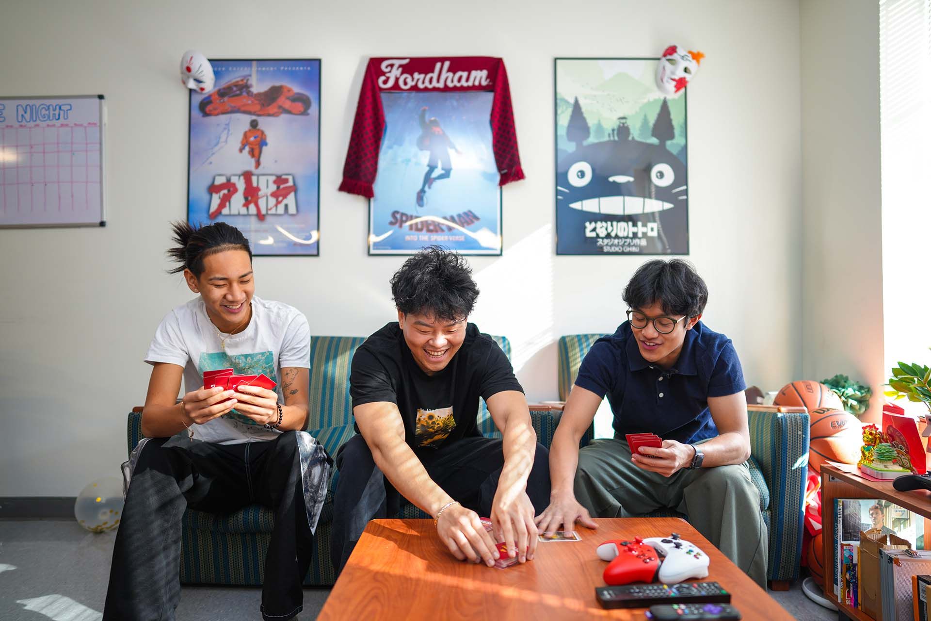 student playing cards in dorm