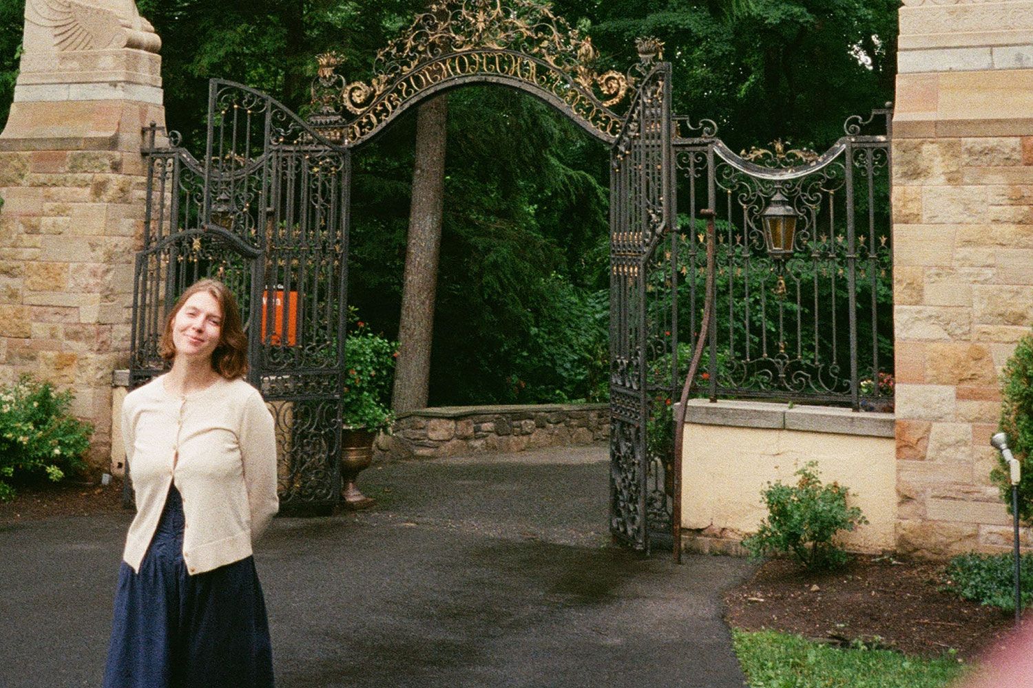 Megan Snopik standing in front of gate and trees