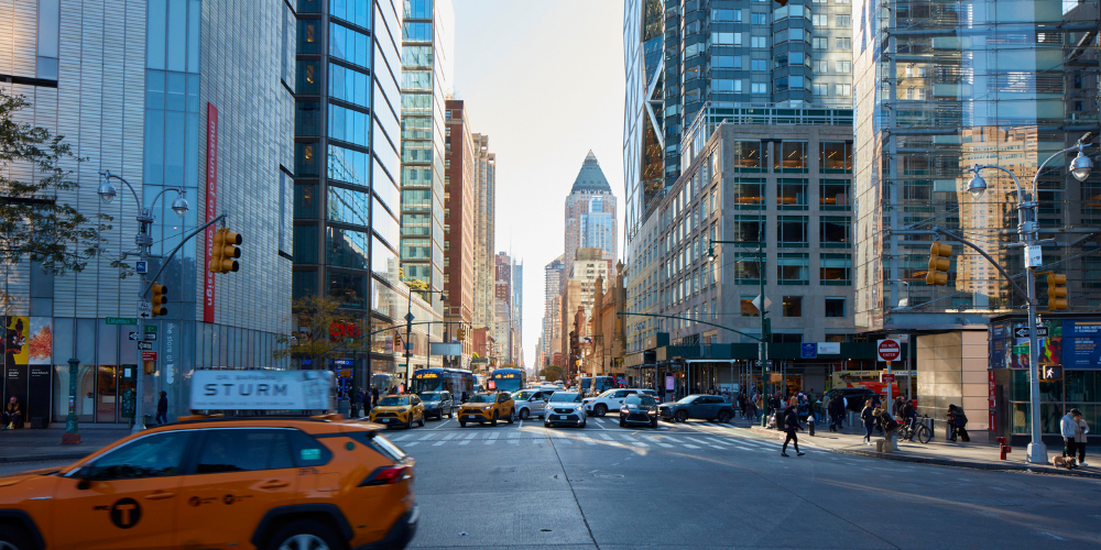 a shot of an nyc city street with a cab in the foreground