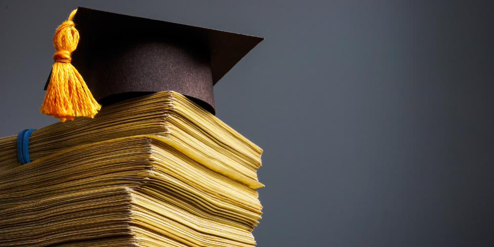 books with a graduation cap on top