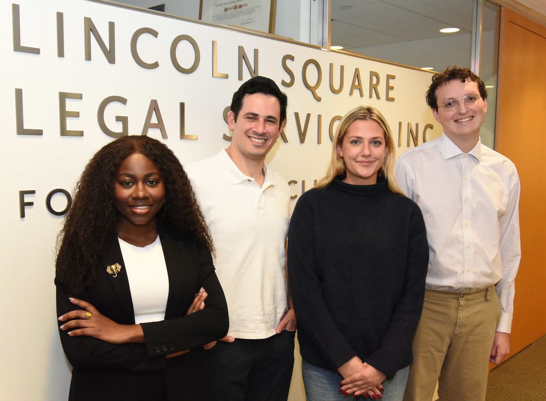 Four students standing in front of an office.