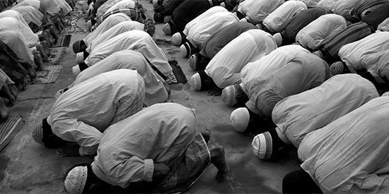 Photo of Muslims in prayer grayscale