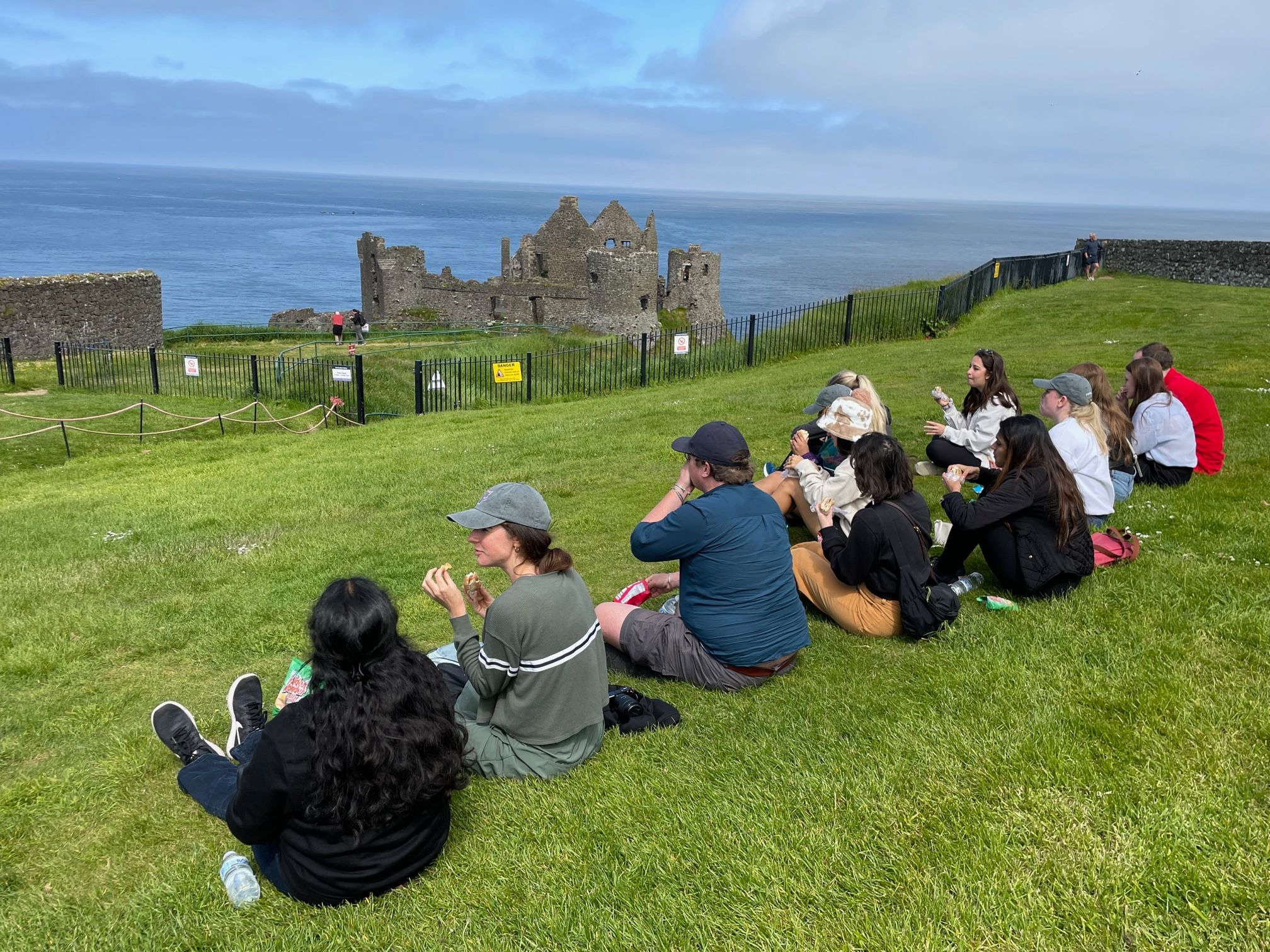 Fordham Law School Ireland summer program 2023 students sitting by castle
